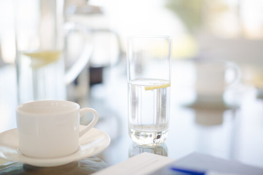 Coffee cup and water glass on meeting table