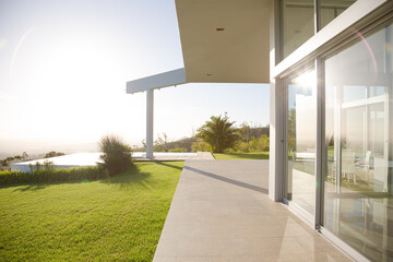 Modern house casting shadows on manicured lawn