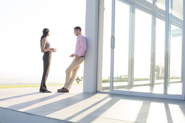 Business people talking outside office