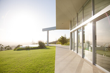 Modern house casting shadows on manicured lawn