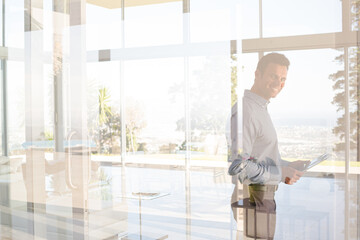 Businessman using cell phone in office