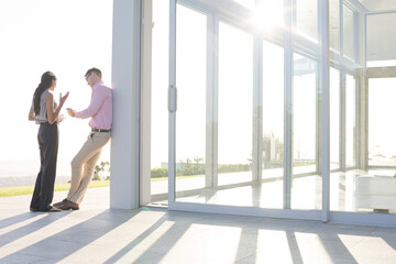 Business people talking outside office