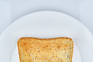 a part of golden crunchy toasted sliced whole wheat sandwich bread .isolated on white dish and white background