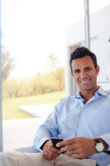 Businessman using cell phone in office