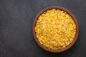 Deep frying  peeled split mung beans in a bowl