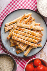 salty sesame bread sticks traditional homemade baked snacks on the table - top view close up healthy vegan or vegetarian food concept