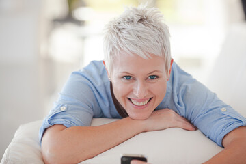 Businesswoman using cell phone on sofa