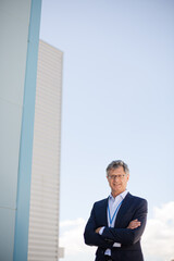 Businessman standing below highrise buildings