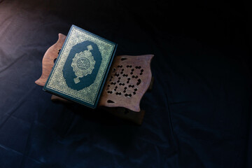 Quran in the mosque - open for prayers The black background of the Muslims around the world placed...