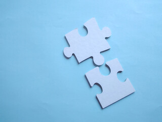 Jigsaw puzzle pieces on blue background. Business solutions, success and strategy.