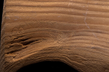 Close-up details of used, distressed, weathered pine pallet wood grain pattern with selective focus for copy space on a black background.