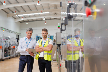Supervisor and worker smiling in factory