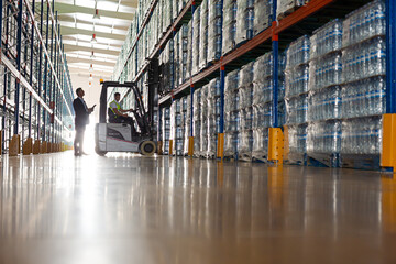 Worker operating forklift in warehouse © KOTO