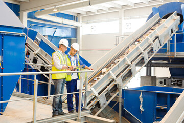 Workers talking in recycling center