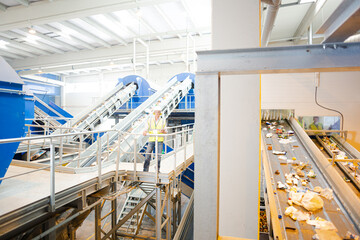 Worker on platform in recycling center