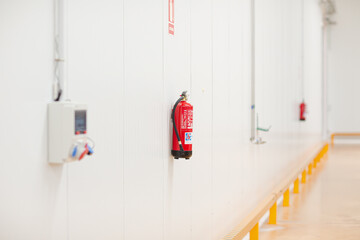 Fire extinguisher on wall in factory