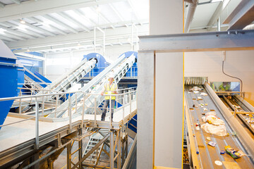 Worker on platform in recycling center