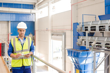 Worker on platform in recycling center