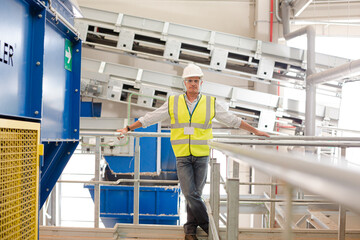 Worker on platform in recycling center