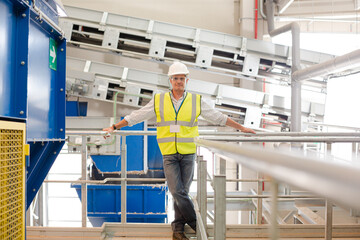 Worker on platform in recycling center