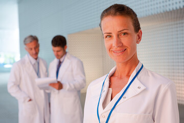 Portrait of confident female doctor in hospital corridor