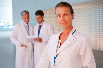 Portrait of confident female doctor in hospital corridor