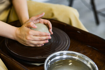 Fototapeta na wymiar making pottery of different shape on pottery wheel