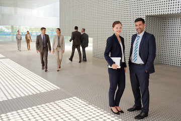 Business people standing outside modern building