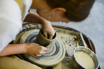 making pottery of different shape on pottery wheel