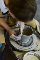 making pottery of different shape on pottery wheel