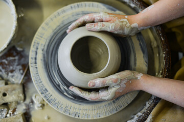 making pottery of different shape on pottery wheel