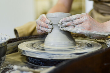 making pottery of different shape on pottery wheel