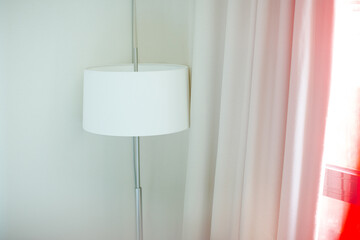 Lamp standing in corner of room