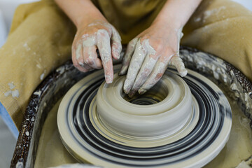 making pottery of different shape on pottery wheel