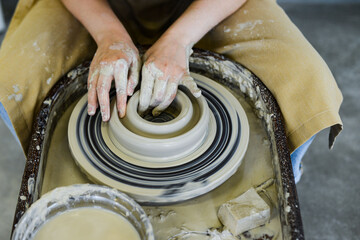 making pottery of different shape on pottery wheel