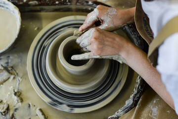 making pottery of different shape on pottery wheel