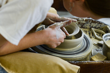making pottery of different shape on pottery wheel