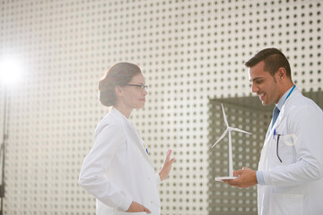 Portrait of scientists holding wind turbine models