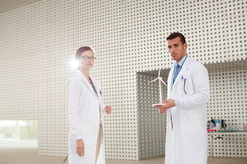 Portrait of scientists holding wind turbine models