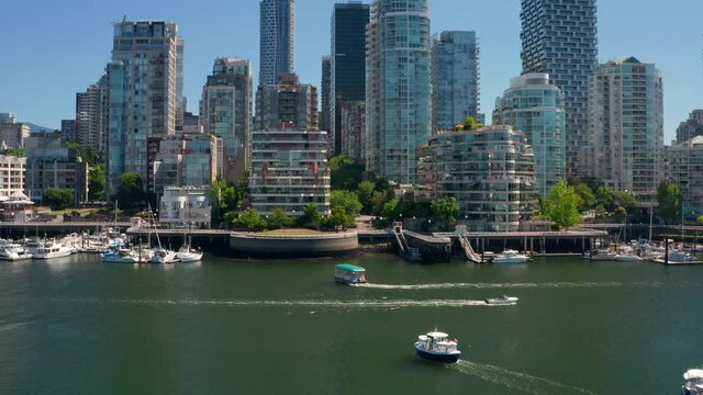 Boats And Aquabus Along False Creek For Sightseeing Services In Downtown Vancouver, British Columbia, Canada. - aerial approach