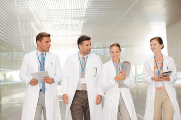 Doctors walking in hospital corridor