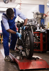 Fototapeta na wymiar Service engineer repairing motorcycle in motorcycle service. High quality photo