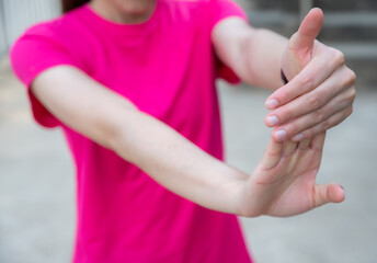 Close up of woman doing stretching fingers before workout. Wrist and hand exercises can reduce the chance of shortened or stiff muscles.