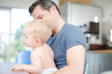 Father holding baby in arms