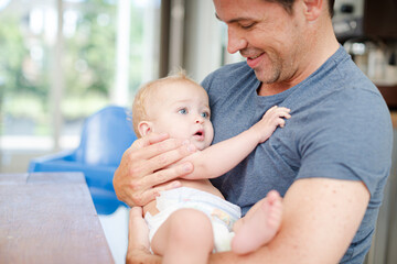 Father holding baby in arms