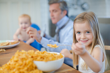 Girl eating overflowing bowl of cereal