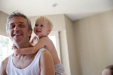Father and son hugging on bed