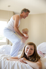 Fototapeta premium Smiling girl laying on bed