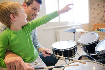 Father and son playing drums together