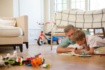 Father and son reading in bedroom